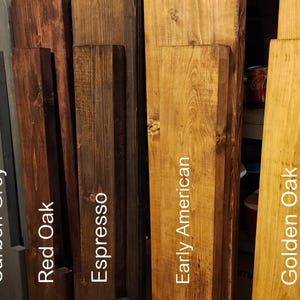 May include: Five wood samples stained in different colors: Carbon Grey, Red Oak, Espresso, Early American, and Golden Oak.