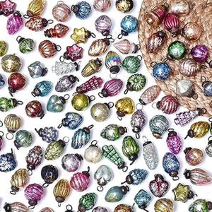 May include: Assortment of vintage-style glass ornaments in various colors and shapes, including round, teardrop, and star shapes. The ornaments have a metallic finish and are perfect for adding a touch of sparkle to your Christmas tree.