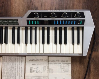 Keytar Formanta mini. Vintage eight-voice keyboard synthesizer in case. Music griffon device with scheme