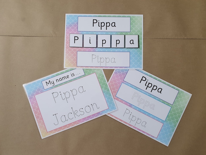 May include: Educational name learning cards featuring the name "Pippa". The cards have a colorful mermaid scale design. One card has the name spelled out with individual letters. Other cards have the name written in a traceable font.