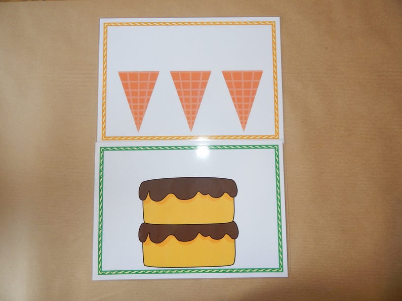 May include: Two illustrated cards. The top card features three orange ice cream cones. The bottom card shows a two-layer yellow cake with chocolate frosting. Both cards have decorative borders.