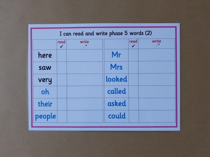 May include: A white educational chart with pink borders and the text "I can read and write phase 5 words (2)". The chart is divided into columns for reading and writing words, with words like "here", "saw", and "Mr" listed.