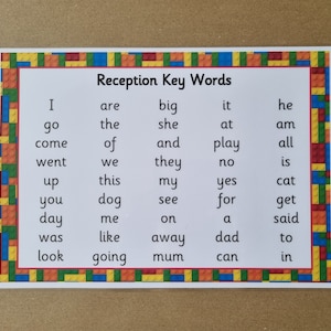 May include: A printed card featuring the words "Reception Key Words" and a list of common words, framed by a colourful toy brick border. Ideal for early years learning and literacy.