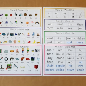 May include: A set of educational phonics mats for early learning. The mats are labelled with "Phase 2 Sound Mat", "Phase 2 - Word Mat", "Phase 3 Sound Mat", "Phase 3 - Word Mat", "Phase 4 - Word Mat", and "Phase 5 Sound Mat". They feature colourful illustrations and words.