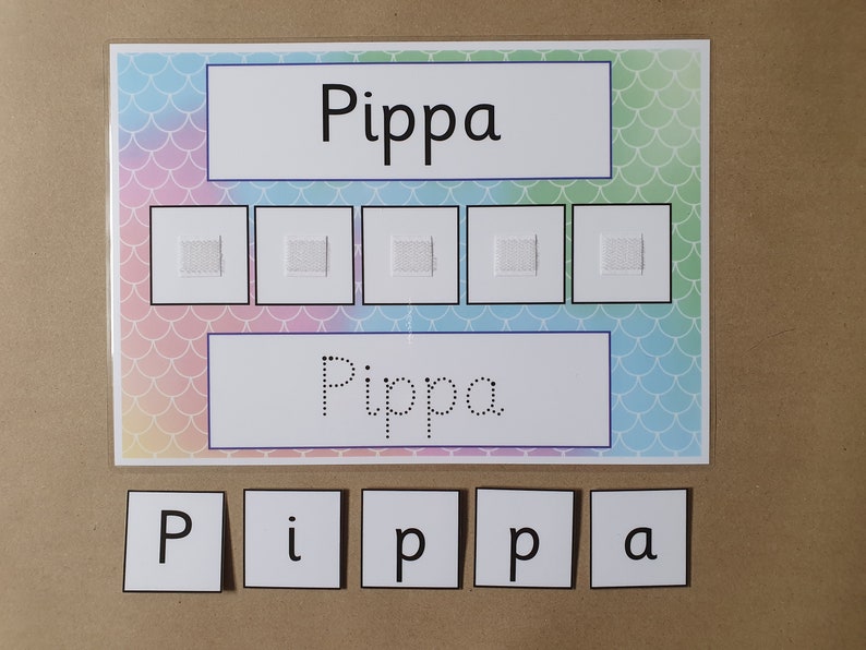 May include: A learning aid featuring the name "Pippa" in large print, dotted print, and individual letter tiles. The background has a mermaid scale pattern in pastel colors. Five squares are above the dotted name.