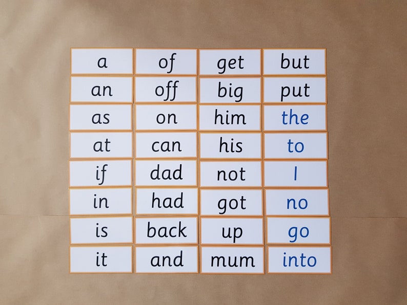 May include: A set of flashcards with sight words printed in a black font, with the word "the" and "go" in blue. The cards are arranged in a grid pattern with a light brown border, set against a light brown background.