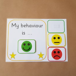 May include: A behaviour chart with the text "My behaviour is ..." and three emoji options: green smiley face, yellow neutral face, and red sad face. Includes two yellow star graphics.