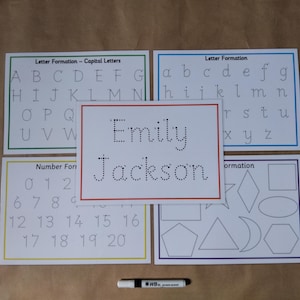 May include: Educational tracing boards for letters, numbers, and shapes. Includes a board with the name "Emily Jackson" in dotted letters, plus a dry-erase marker. Ideal for early learning and handwriting practice.