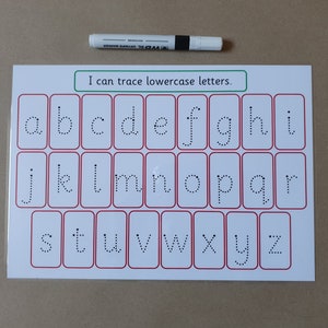May include: A white educational tracing sheet with lowercase letters a-z in dotted lines, framed in red rectangles. The text "I can trace lowercase letters" is above the letters. A white and black marker is at the top.