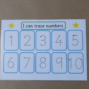 May include: A white educational card with blue borders and the text "I can trace numbers." Features numbers 1-10 in dotted lines for tracing practice. Includes yellow star accents.