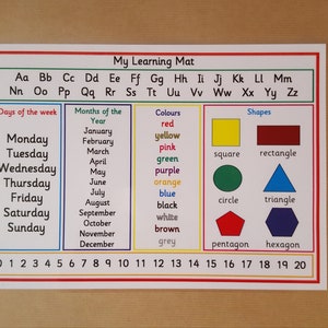 May include: A learning mat titled "My Learning Mat" displays the alphabet, days of the week, months of the year, colours, shapes, and numbers 0-20. The mat is designed for educational purposes.