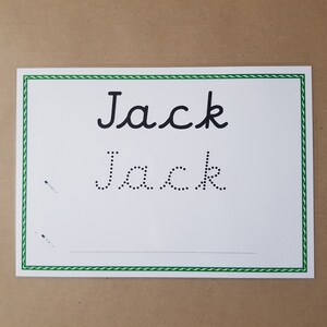 May include: A white rectangular practice sheet with a green wavy border. The name Jack is printed in black cursive at the top, followed by the name Jack in a dotted line font for tracing, and a single dashed line at the bottom for writing.