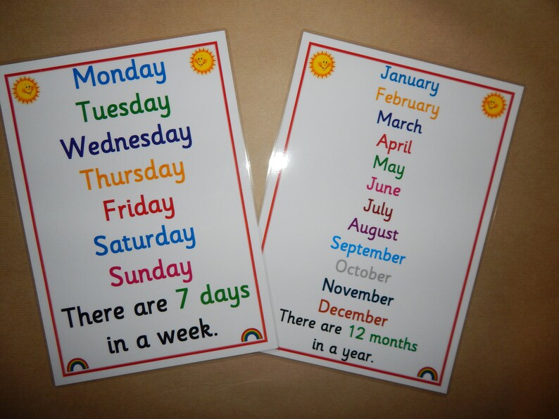 May include: Two educational posters with the days of the week and months of the year. The days are listed in a rainbow of colors, with a smiling sun graphic in the corners. The text "There are 7 days in a week" is included.