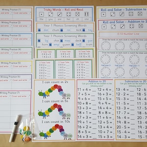 May include: A set of educational cards for children, including maths problems, phonics, and writing practice. Features multiplication tables, addition, subtraction, and a number line. Designed for early learning.