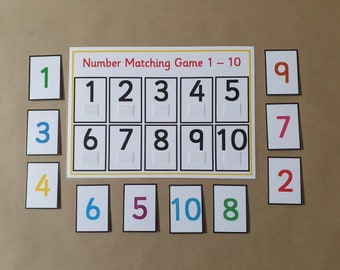 May include: A number matching game with the text "Number Matching Game 1 - 10". The game includes a central board with numbers 1-10 and corresponding cards. Each number is in a different color, with braille below.