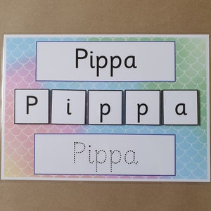 May include: A learning aid featuring the name "Pippa" in large, bold letters and individual letter tiles. The background has a pastel mermaid scale pattern. The name is also shown in dotted letters for tracing.