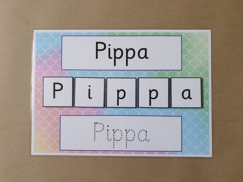 May include: A learning aid featuring the name "Pippa" in large, bold letters and individual letter tiles. The background has a pastel mermaid scale pattern. The name is also shown in dotted letters for tracing.