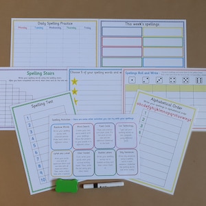 May include: A collection of laminated spelling practice worksheets with colourful borders, including charts for daily practice, spelling stairs, roll and write games, and alphabetical order. A small green eraser and a dry erase marker are included.