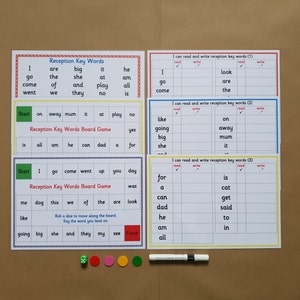 May include: A collection of educational resources for early years learning. The image displays key word boards, a board game, and writing practice sheets. Includes dice, counters, and a whiteboard marker. The boards feature words like "go", "the", and "big".