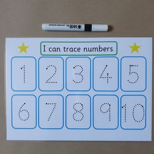 May include: A white educational worksheet with the text "I can trace numbers." Features numbers 1-10 in dotted lines for tracing. Includes a white dry-erase marker. The worksheet has a blue border and yellow star accents.