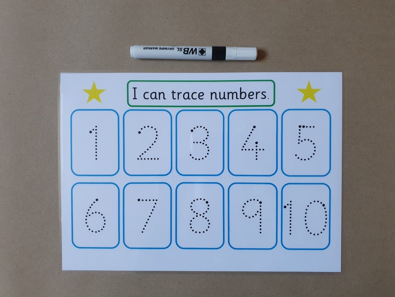 May include: A white educational worksheet with the text "I can trace numbers." Features numbers 1-10 in dotted lines for tracing. Includes a white dry-erase marker. The worksheet has a blue border and yellow star accents.