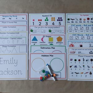 May include: Educational learning mats for children, featuring numbers, letters, shapes, and CVC words. Includes a whiteboard marker and colorful counters. The mats are designed for early childhood education.