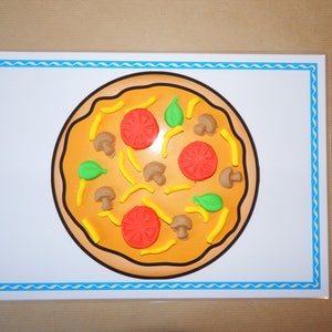 May include: A colorful pizza illustration on a white background with a blue border. The pizza features red tomato slices, green basil leaves, brown mushrooms, and yellow pepper strips. The crust is a light brown color.