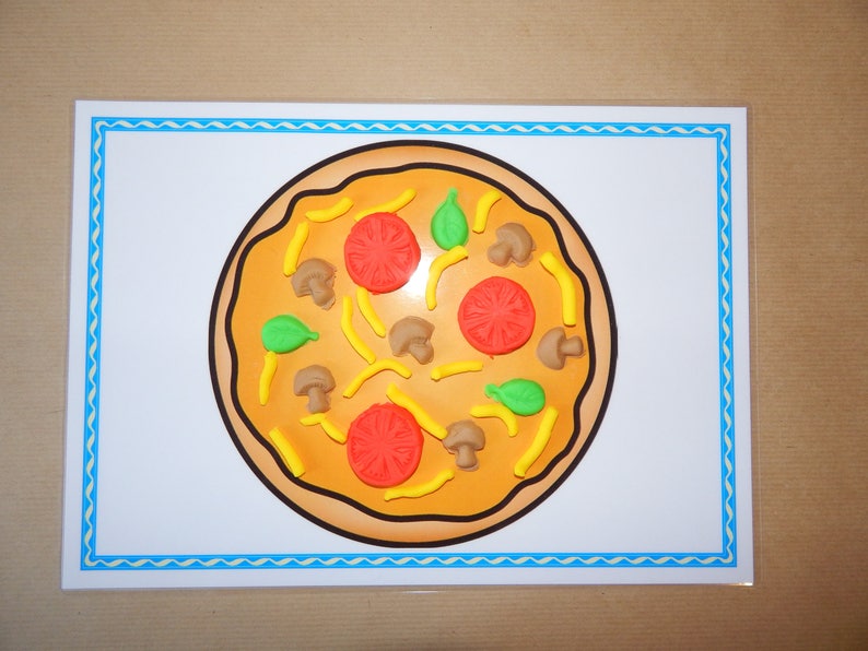 May include: A colorful pizza illustration on a white background with a blue border. The pizza features red tomato slices, green basil leaves, brown mushrooms, and yellow pepper strips. The crust is a light brown color.