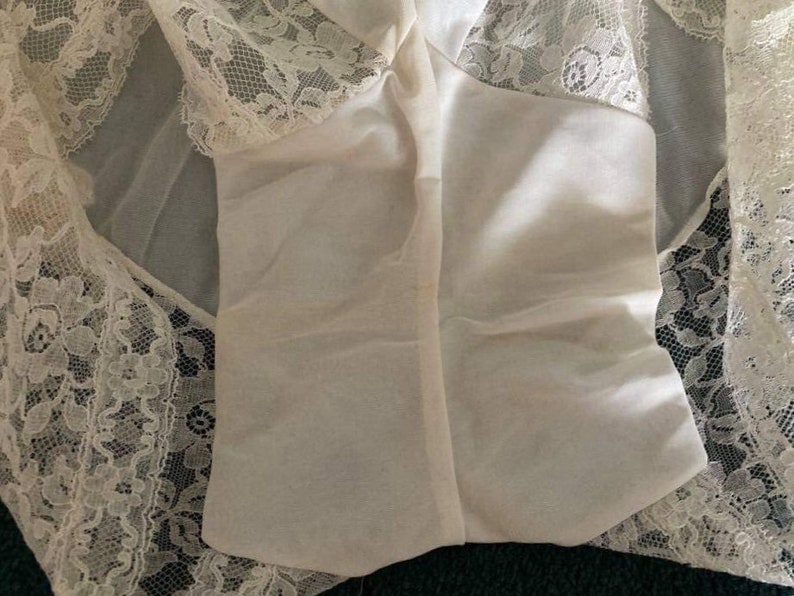 May include: White lace lingerie with a sheer overlay and a delicate floral pattern.