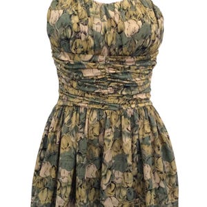 May include: A green and yellow floral print halter dress with a fitted bodice and a flowing skirt.