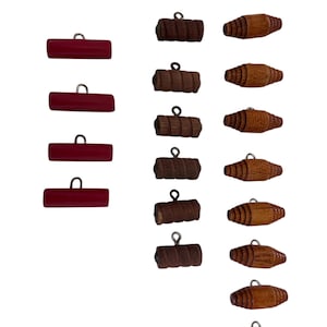 May include: A set of 15 wooden buttons, with 4 red buttons and 11 brown buttons. The buttons have a hole in the top for sewing.