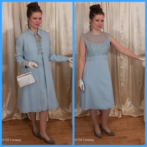May include: A light blue dress with a sheer lace bodice and a matching jacket. The dress and jacket have a simple, elegant design. The model is wearing silver gloves and shoes.