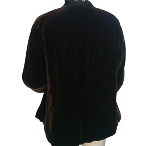 May include: A brown velvet jacket with a black lace collar.