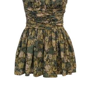 May include: A green and yellow floral print halter dress with a fitted bodice and a flowing skirt.