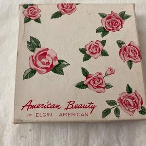 Vintage compact gold and silver floral design round American Beauty by ELGIN AMERICAN in original packaging collectible compact