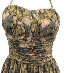 May include: A green and yellow floral print halter dress with a fitted bodice and a full skirt.