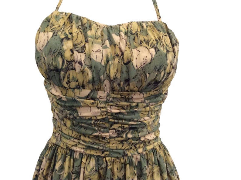 May include: A green and yellow floral print halter dress with a fitted bodice and a full skirt.