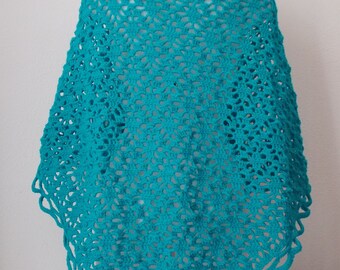 blue shawl is made entirely by hand with crochet.