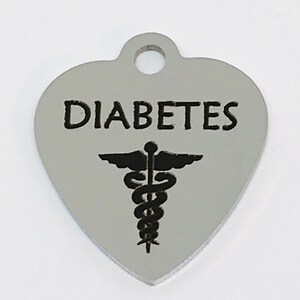 May include: Silver heart-shaped medical alert tag with the word "DIABETES" and a caduceus symbol.