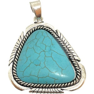May include: A triangular pendant featuring a central light blue stone with dark brown veining. The stone is encased in a silver-toned metal frame with a twisted rope border and etched feather-like details along the edges, topped with a bail.