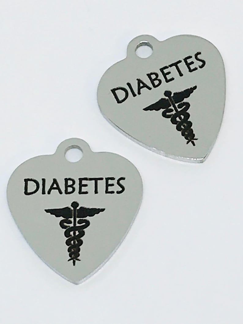 May include: Two silver heart-shaped charms with the word "DIABETES" and a medical caduceus symbol.