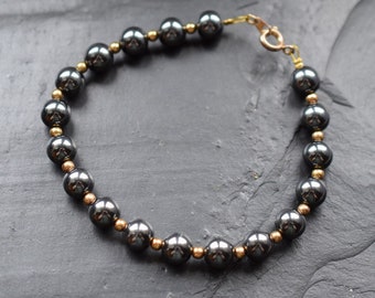 Vintage hematite bracelet | Gold-tone spacer beads | Classic pearl jewelry | Elegant bracelet | Spring ring clasp | Gift for her