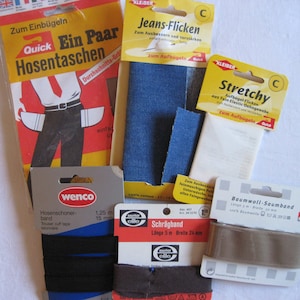 Könnte beinhalten: Sortiment an Stoff-Patches und -Borten zum Reparieren und Basteln.  Enthält Jeans-Patches, einen weißen dehnbaren Stoff-Patch, eine braune Baumwoll-Borte und eine schwarze elastische Borte.  Die Verpackung enthält die Wörter "Jeans-Flicken", "Stretchy", "Baumwoll-Saumband" und "Quick".