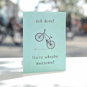 Wheelie Awesome Well Done Card - with bicycle doing wheelie and text: "Well done! You're wheelie awesome!" Great for cycling fans