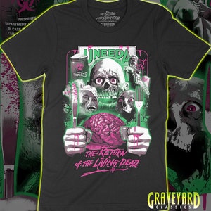May include: Black t-shirt with a graphic print of a zombie head with a brain in its hands and a knife and fork. The text "The Return of the Living Dead" is printed below the graphic. The text "GraveYard Classics" is printed at the bottom of the shirt.