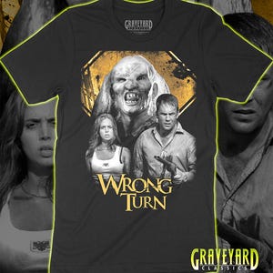 May include: A black short-sleeve t-shirt featuring a graphic print from the movie Wrong Turn. The design displays a monstrous figure above a woman and a man holding a shotgun, with the text Wrong Turn in yellow and Graveyard Classics branding.