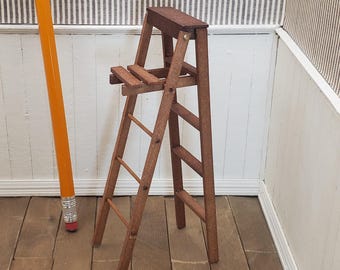 Dollhouse miniature wood stepladder. 1:12 scale 5-inch ladder hinged walnut stained with shelf.