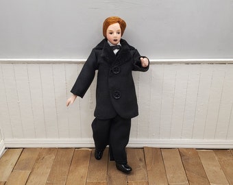 Dollhouse miniature Victorian adult male doll in black suit with porcelain hands, feet and head. Poseable doll for miniature scene.