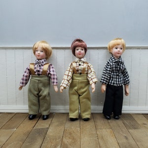 1/12 scale dollhouse miniature boy doll with porcelain hands, feet and head. Fiber hair. Fully poseable doll for miniature scene.
