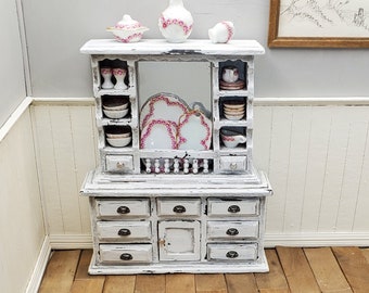1:12 scale artisan crafted shabby chic hutch with mirror. Miniature aged chest of drawers with pewter cup pulls. Heirloom dollhouse piece.